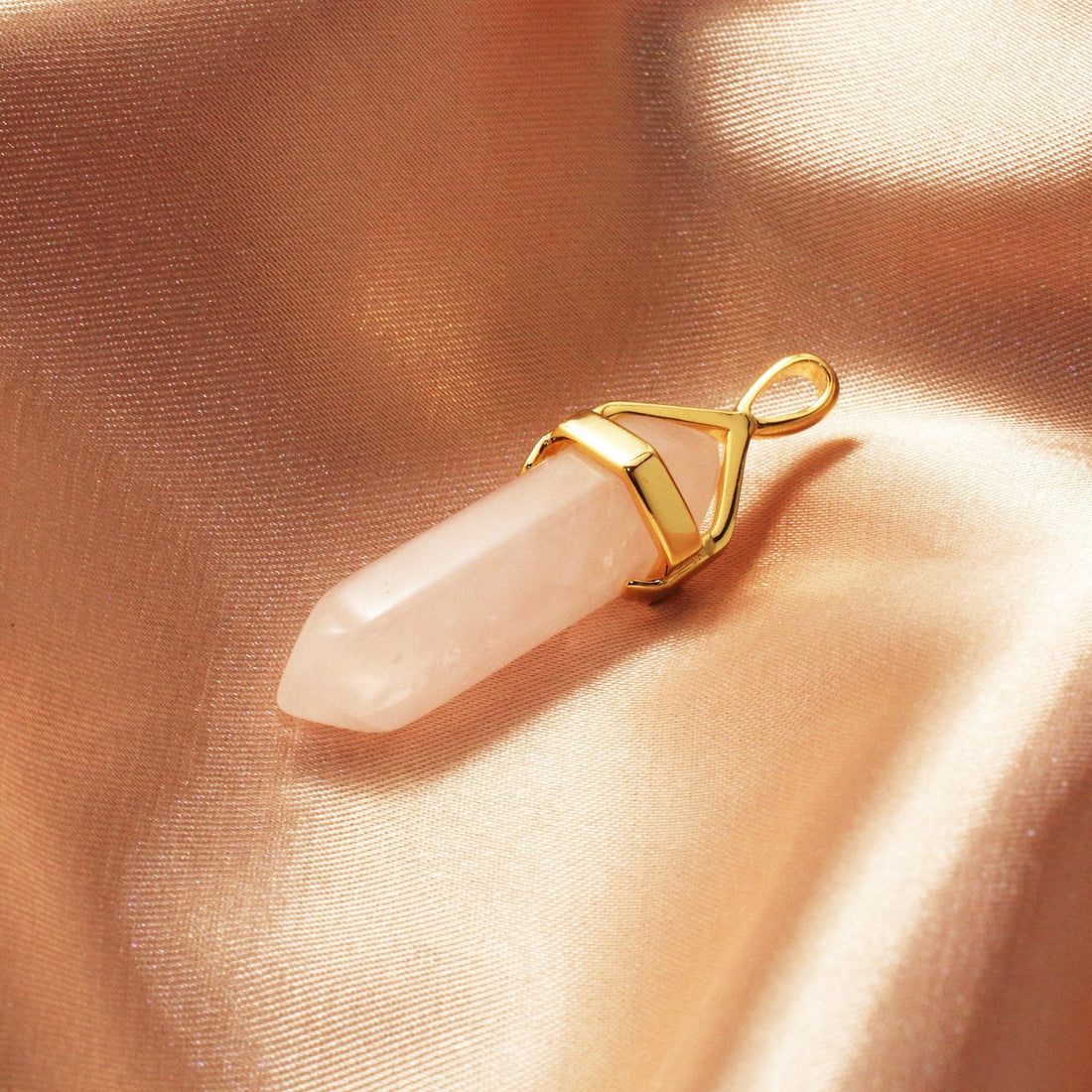 Chainstones Rose Quartz necklace showing soft pink color, natural-looking translucency and elongated crystal point shape