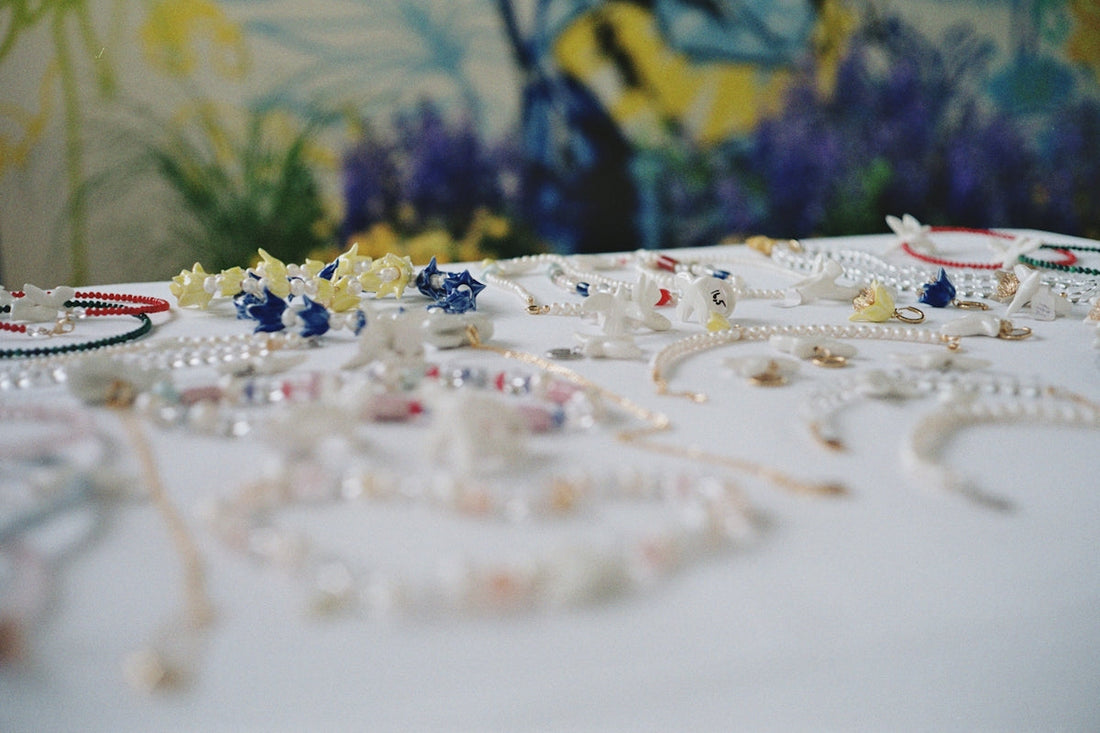 a table topped with lots of different types of jewelry
